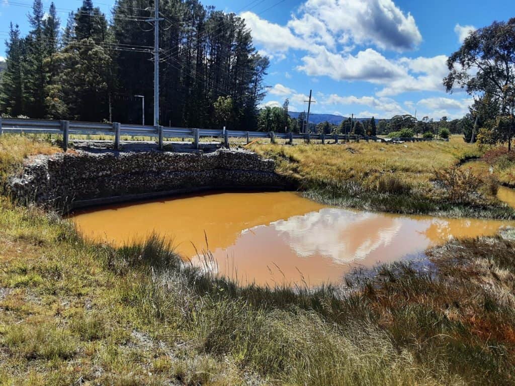 Water from licensed discharge point LDP001, which flows into Wangcol Creek, photographed on 2 December 2025 when salinity measured 4,250 μS/cm.  Supplied by Lithgow Environment Group and used with permission.